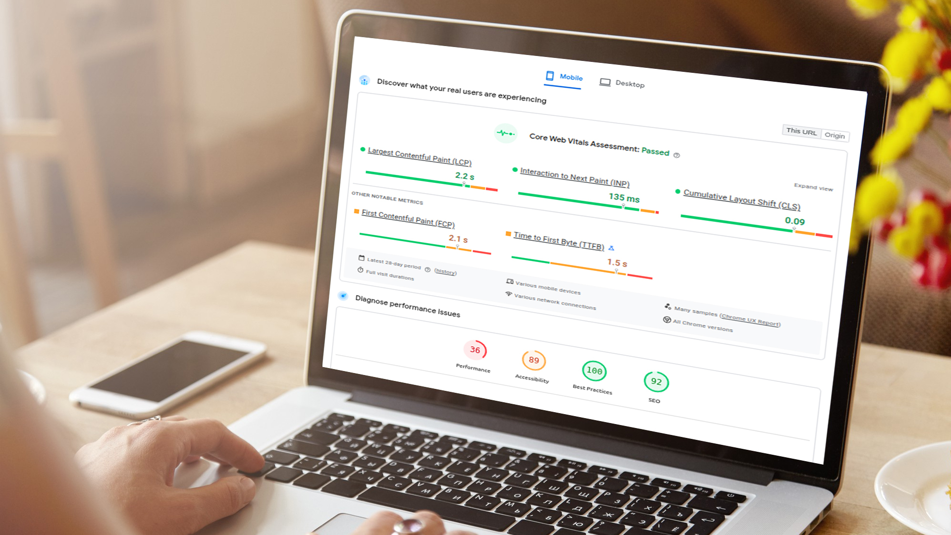 Person using laptop showing Core Web Vitals metrics and website performance dashboard